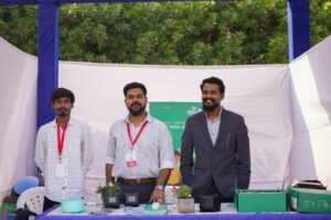 Student founders reviewing revenue dashboard in startup workspace.